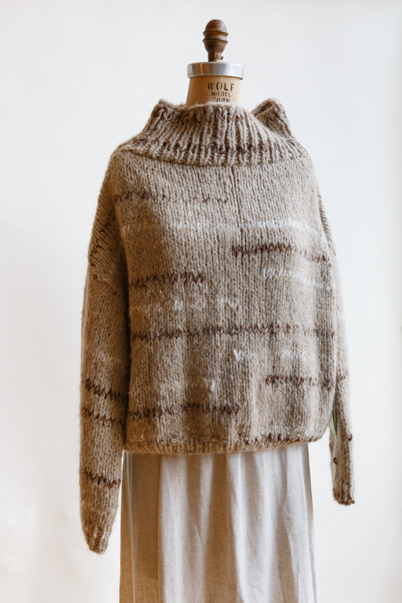 On display on a mannequin, this oversized sweater is handcrafted in South American by Ursa Textiles and is made from the highest quality natural fibers sourced locally in Patagonia and The Andes