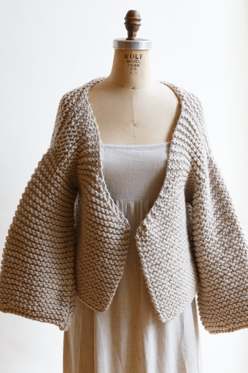 Handcrafted by women artisans in South America and made from the highest quality natural fibers sourced in Patagonia and The Andes, this chunky merino wool cardigan sweater is slightly cropped and is on display on a mannequin