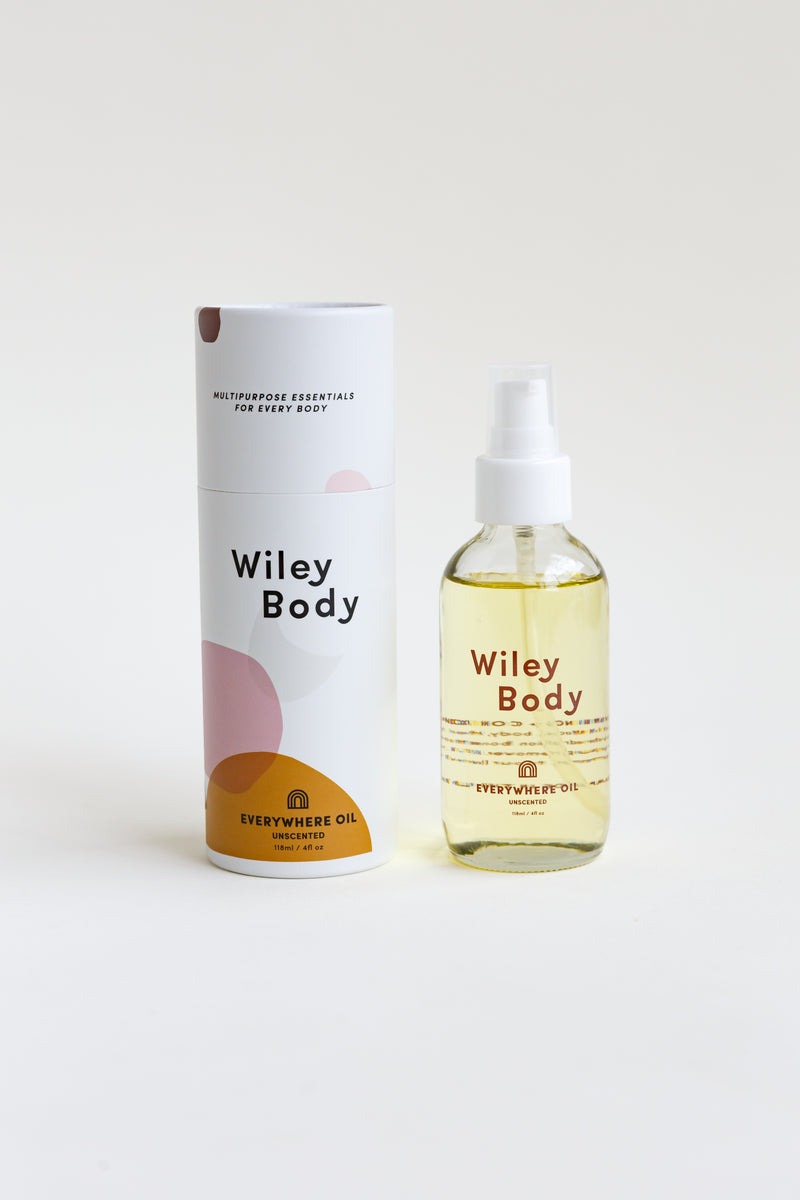 A bottle of Wiley Body Everywhere Oil, crafted from a skin-loving botanical blend of lightweight cold-pressed oils, sitting on a table